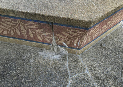 Crumbling cement at the base of the fountain before repair