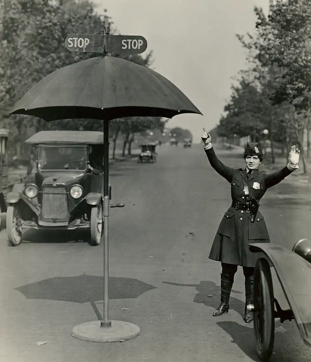 Police woman in the 1920s directing traffic
